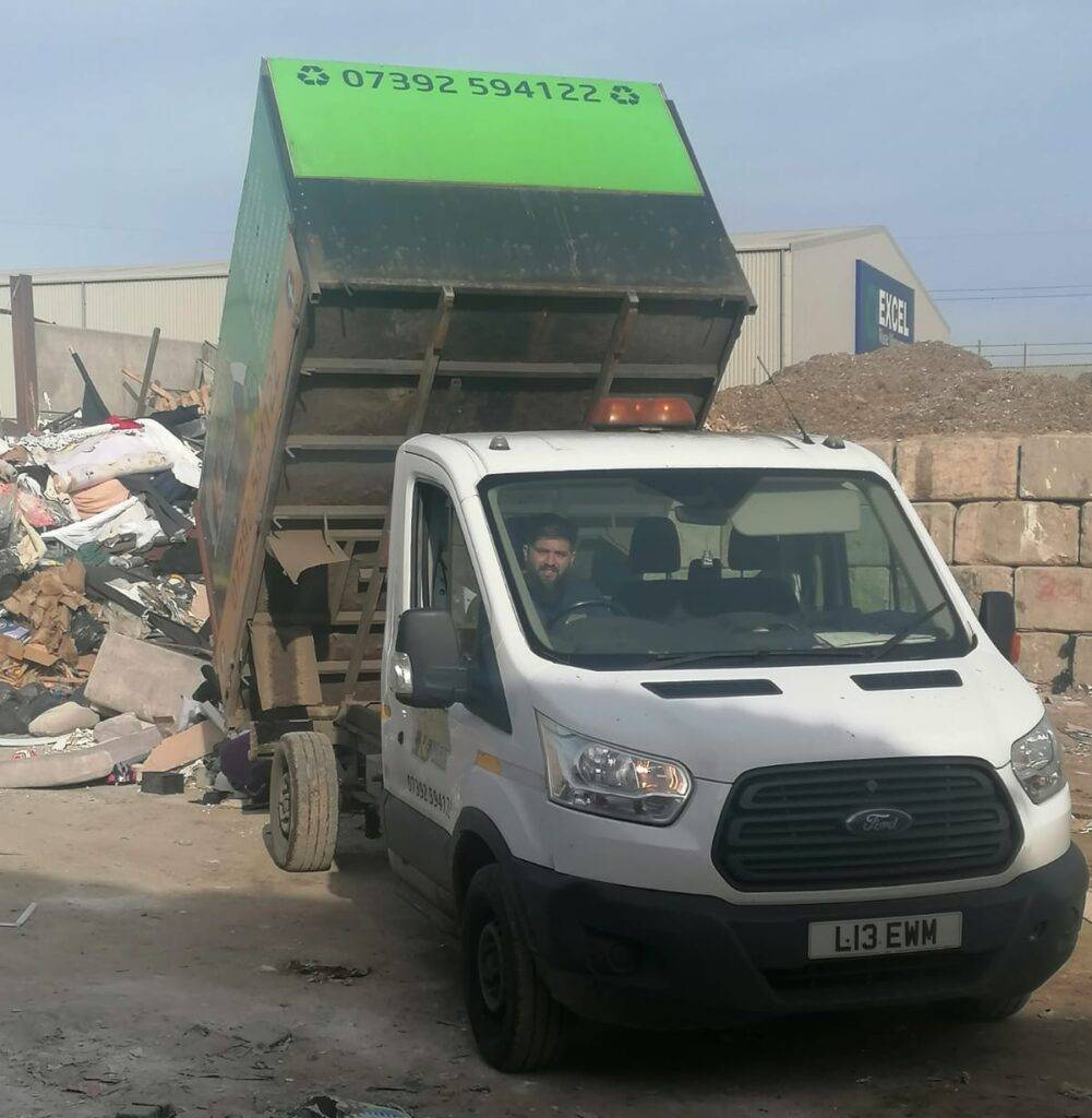 Essex Waste Man worker sitting in the removal van where they take rubbish